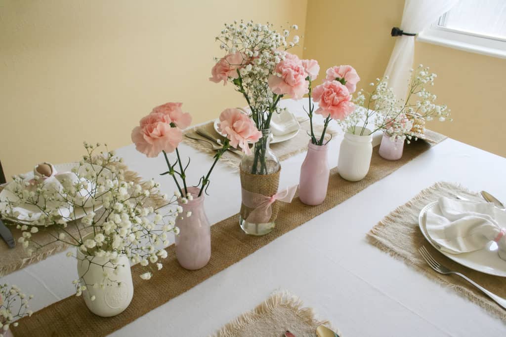 Row of vases on Easter table setting