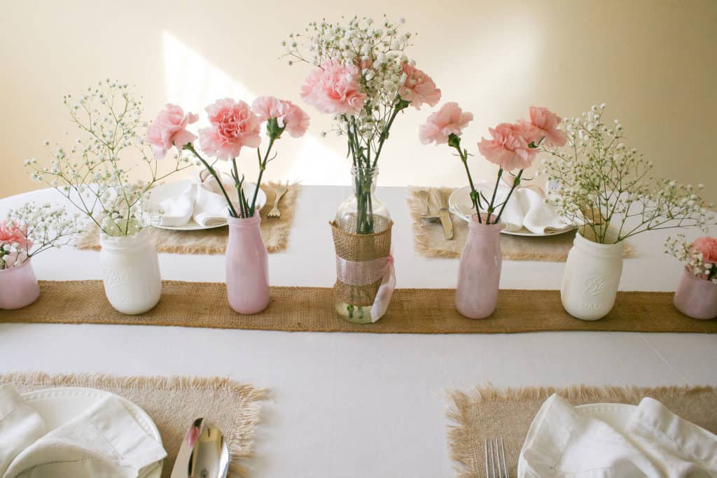 Line of vases on Easter table setting