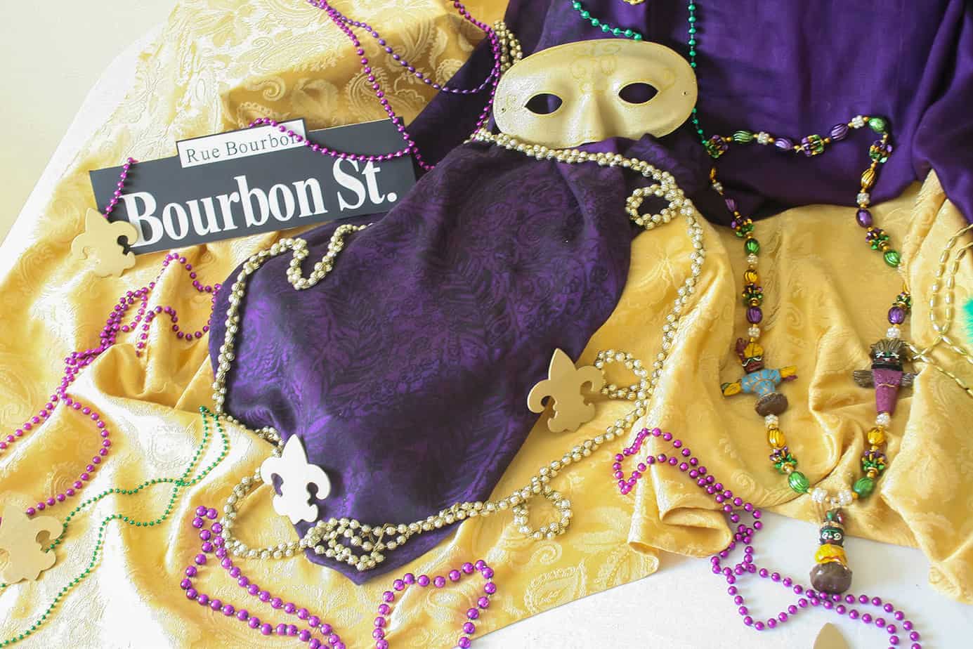 Mardi Gras - gold and purple tablecloth with mask and beads
