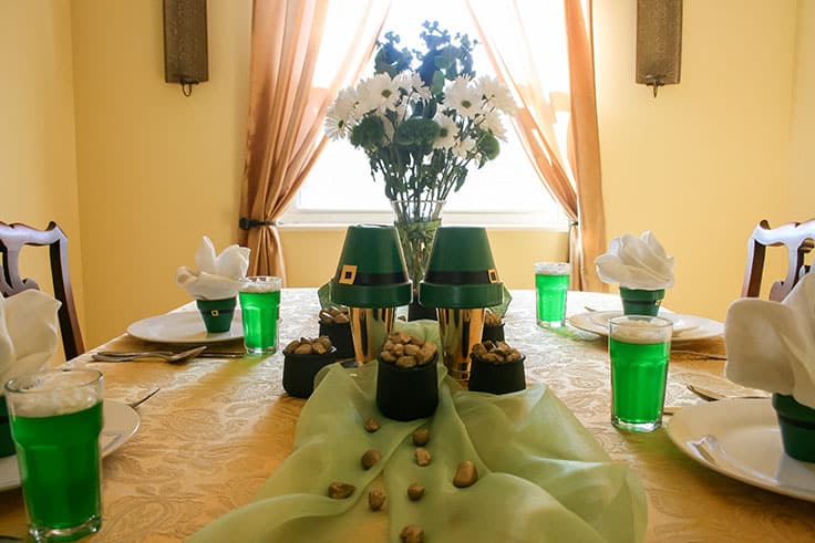 St. Patrick's Day table setting with pots of gold and DIY leprechaun hats