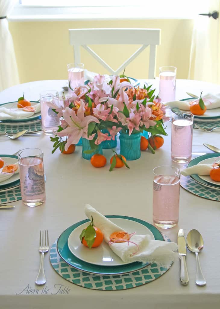 Centerpieces three ways - table setting with 6 teal vases creating round arrangement