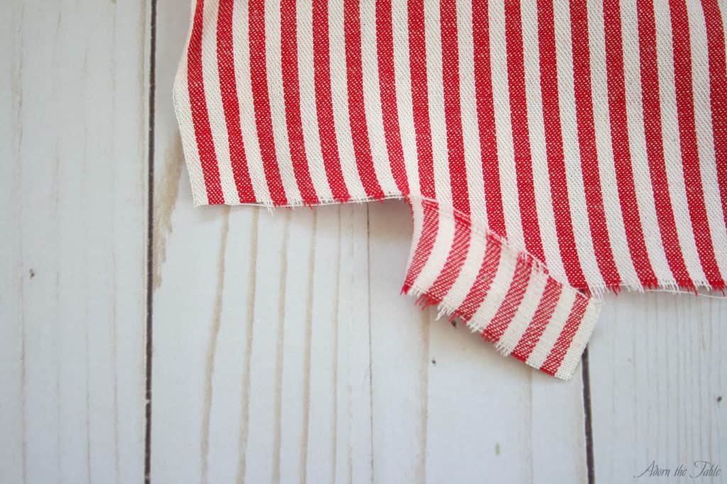 Ripped red and white striped fabric