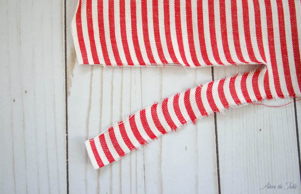 Ripped red and white striped fabric