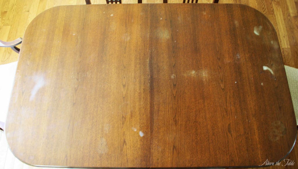 Old wood table with hazy white stains-before