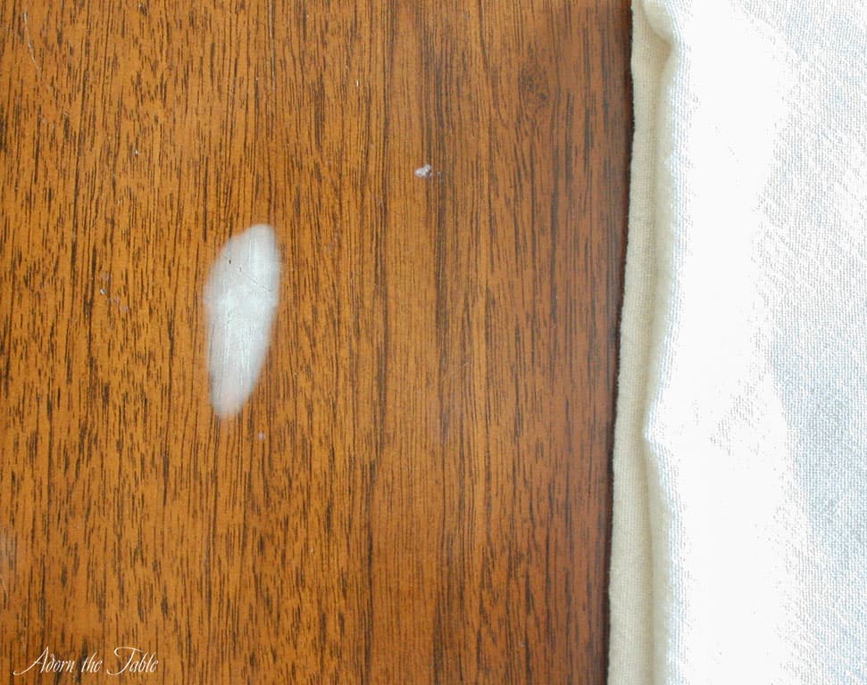 Hazy white stain on old table-before