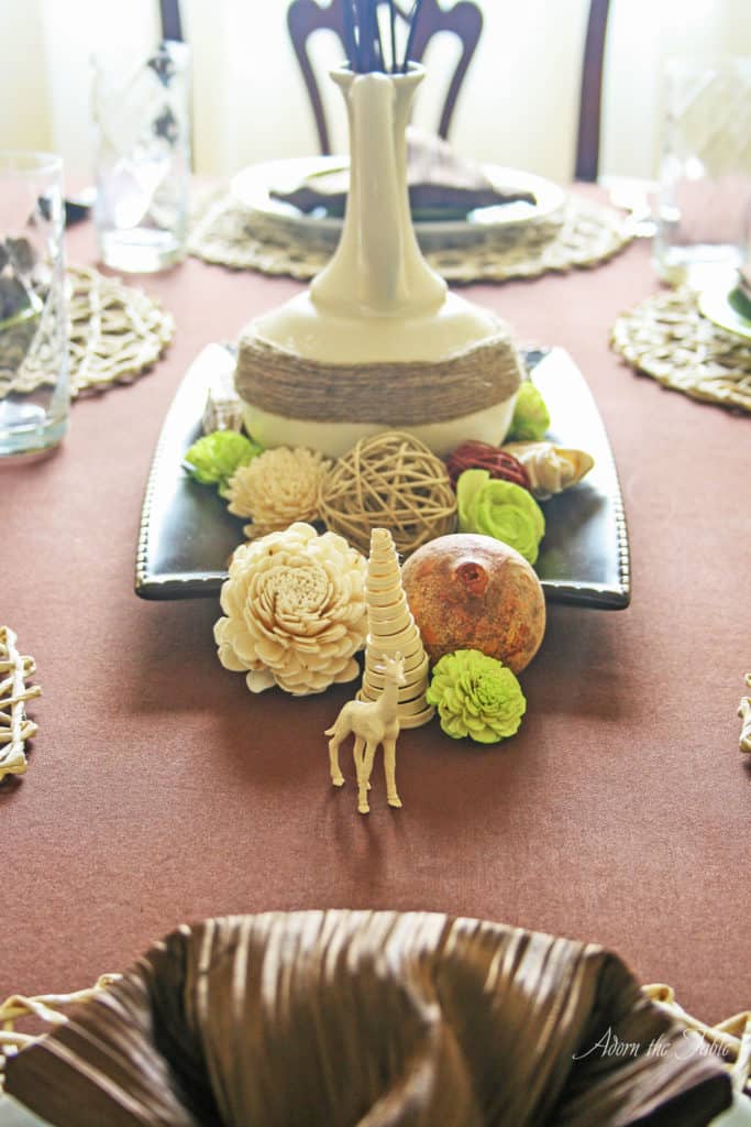 safari centerpiece with cream vase and dried flowers