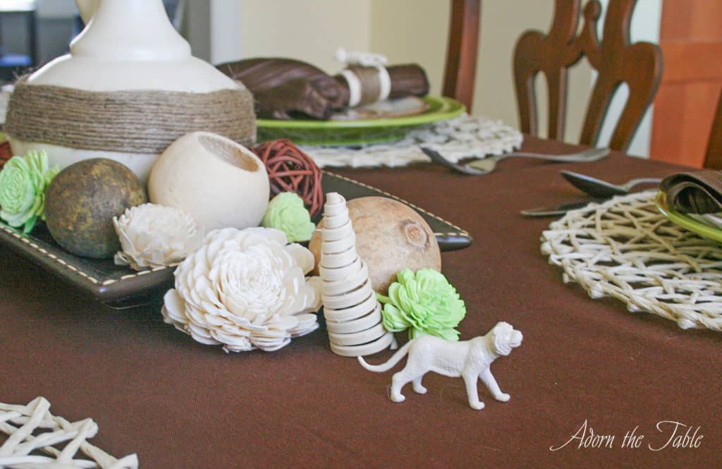 dried flowers and small cream tiger on safari tablescape