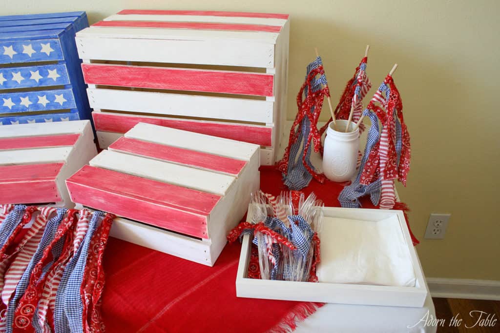 overhead view of red and white diy wooden craft crates and ripped fabric flags in red, white and blue