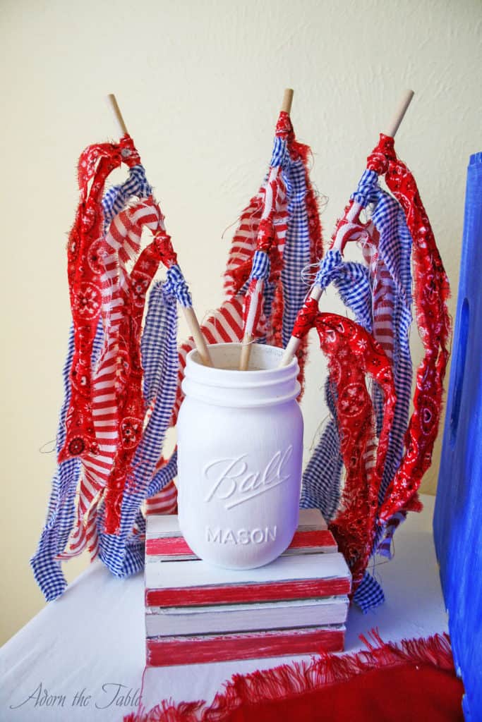 ripped fabric flag in painted white mason jar