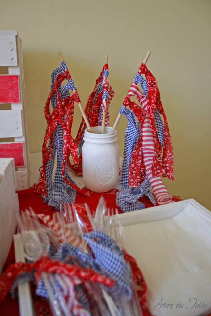 closeup of ripped fabric flags on memorial day table