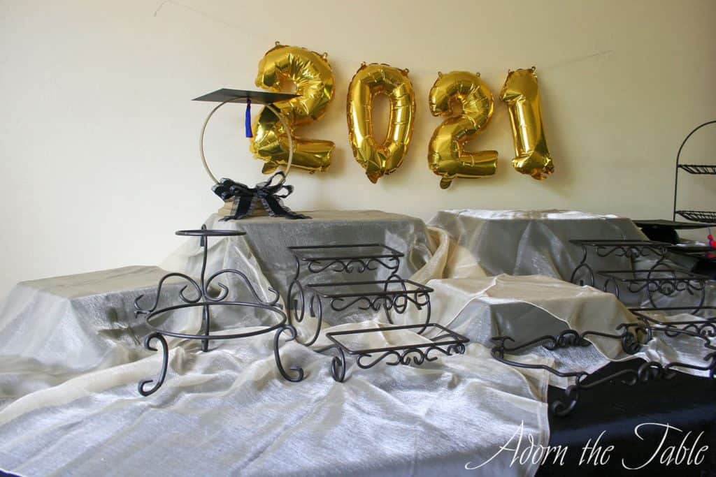 Graduation-Buffet-Table-black tablecloth, gold accent layer and graduation centerpiece-left-side