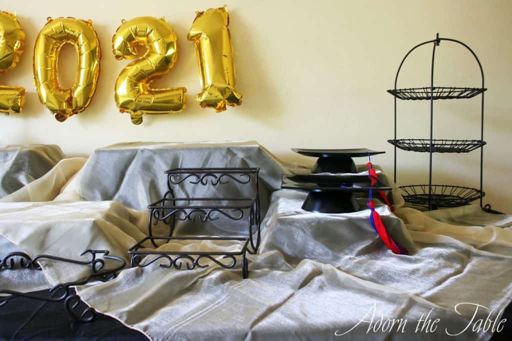 Graduation-Buffet-Table-black tablecloth, gold accent layer and graduation centerpiece-right-side