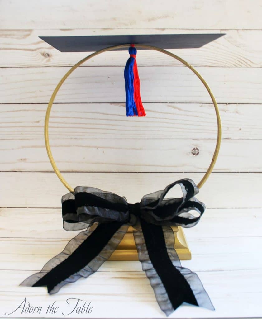 Completed diy graduation centerpiece with black bow added.