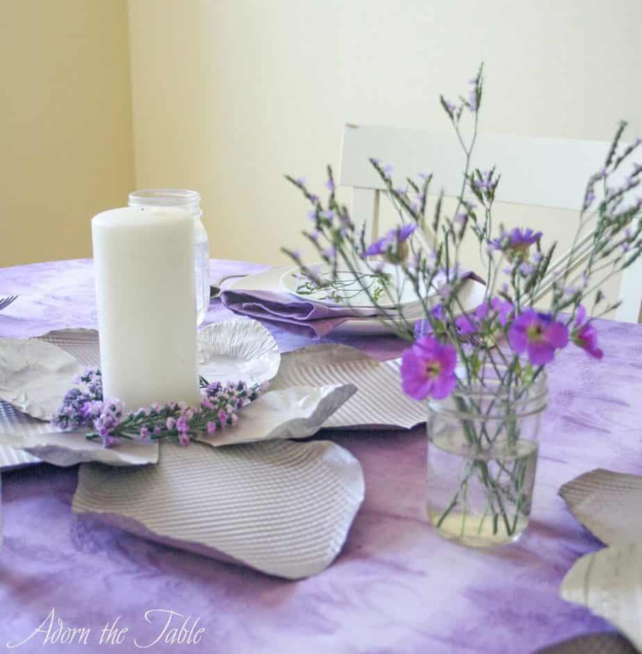 Simple lilac and white flower arrangement on tie-dyed tablecloth