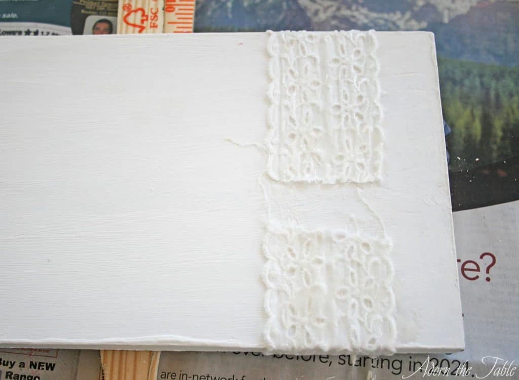 Bottom of white wooden tray with lace