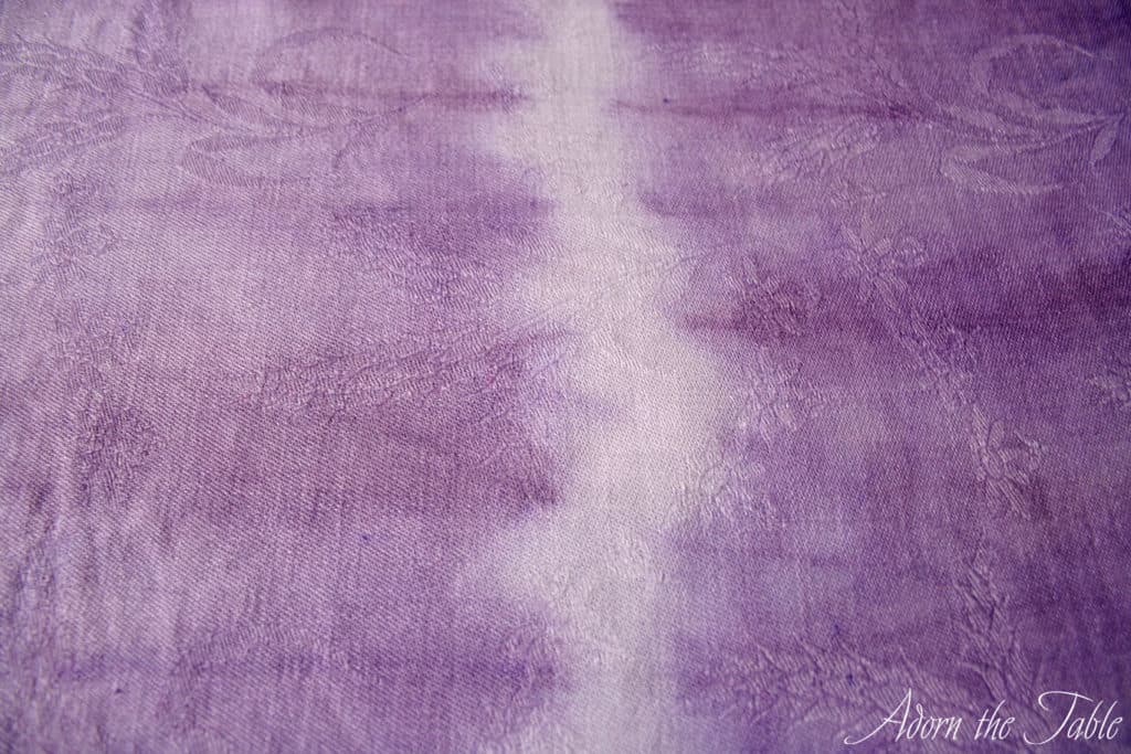 Close up of tie dyed lilac and white tablecloth
