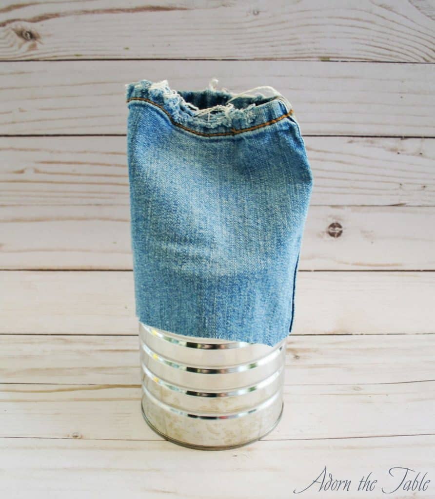 Placing jeans cut pant leg over coffee can