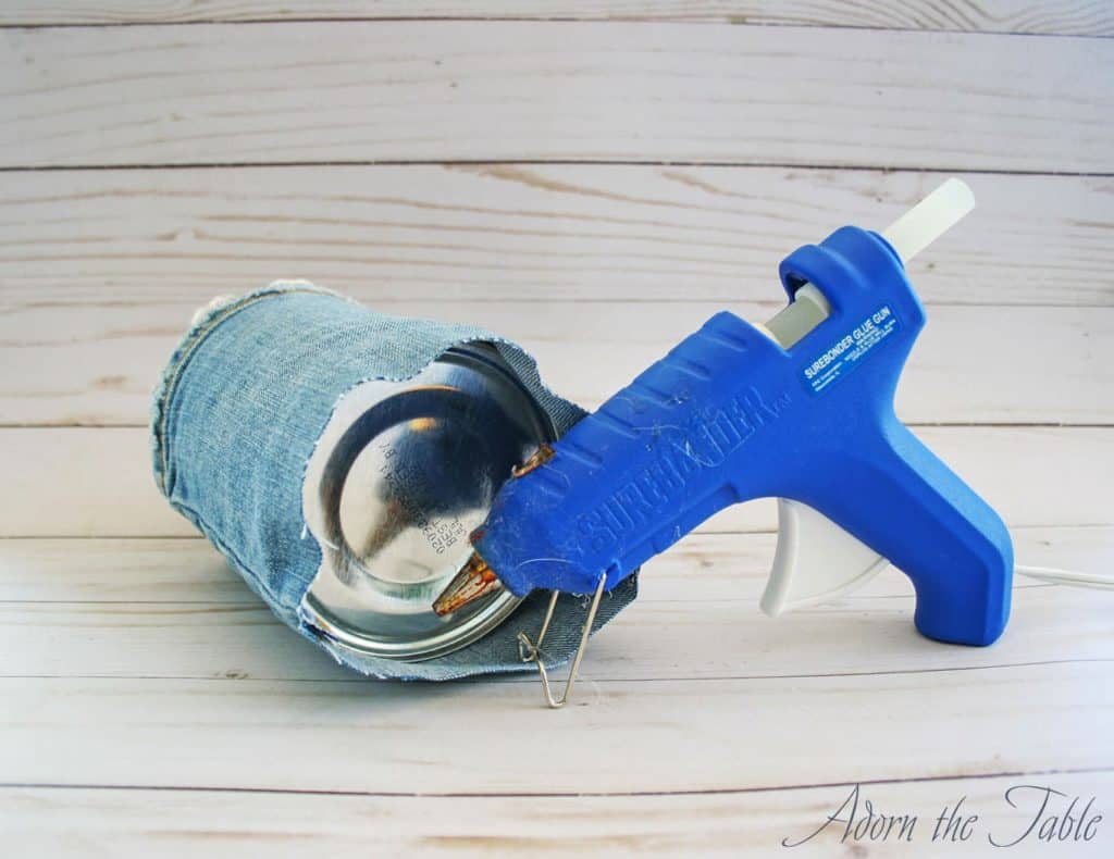 Hot glue jeans to bottom of coffee can