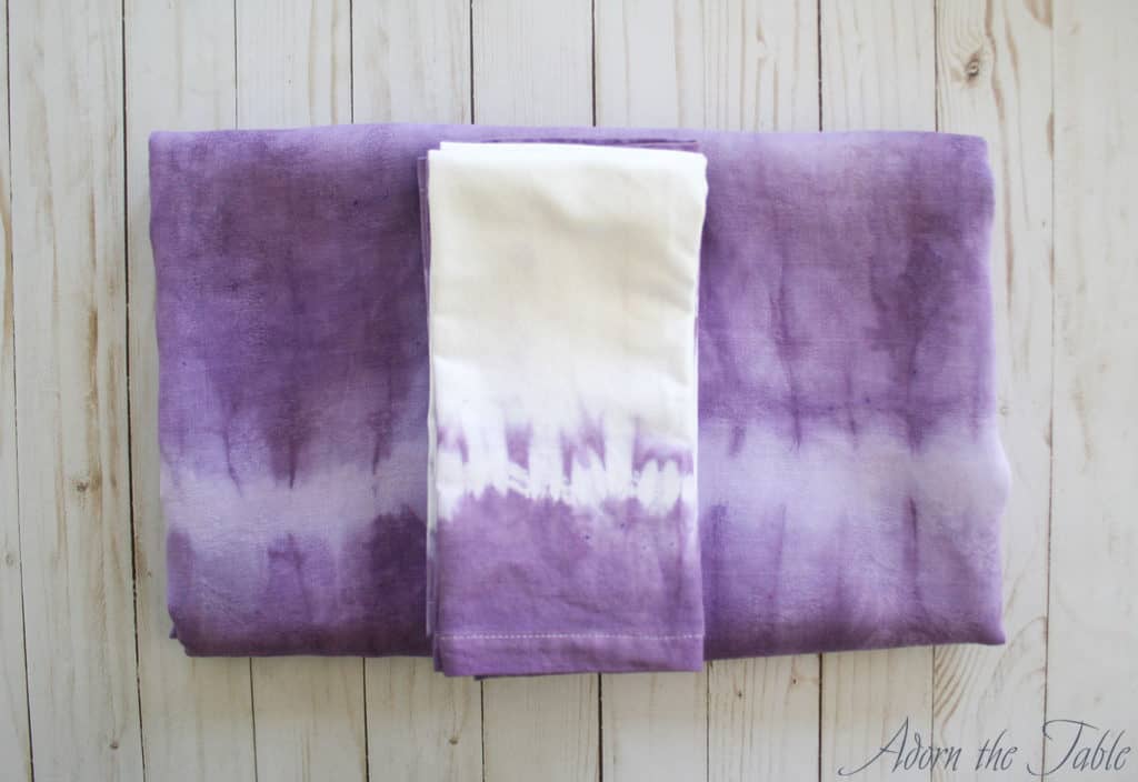 Lilac-and-white-tie-dyed-tablecloth-and-napkins folded