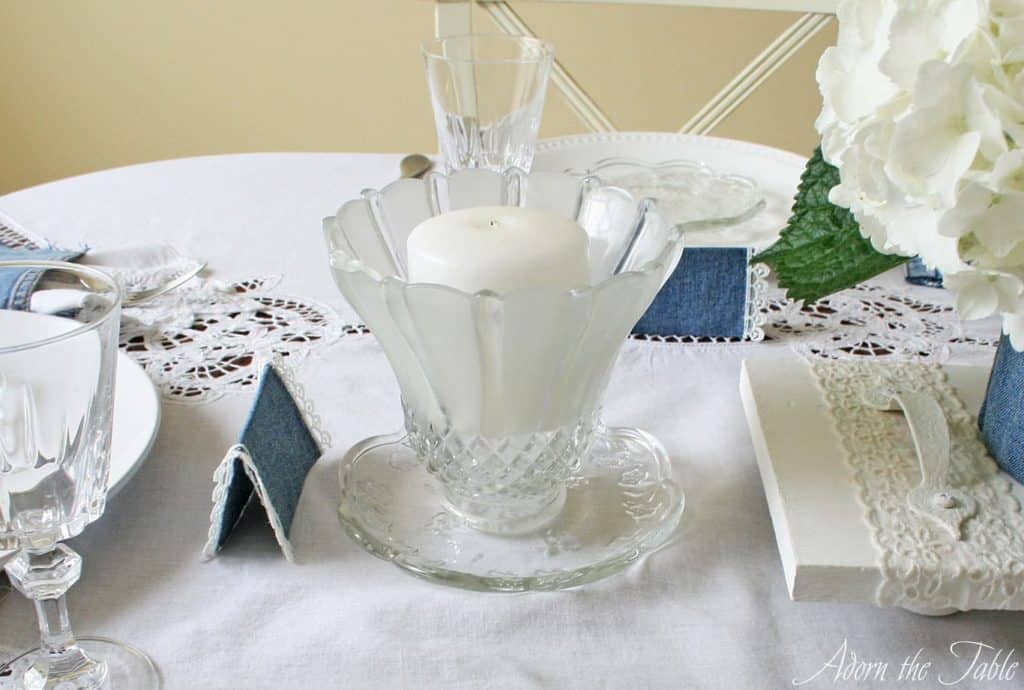 Candle holder made from clear small plate and clear glass lamp shade.