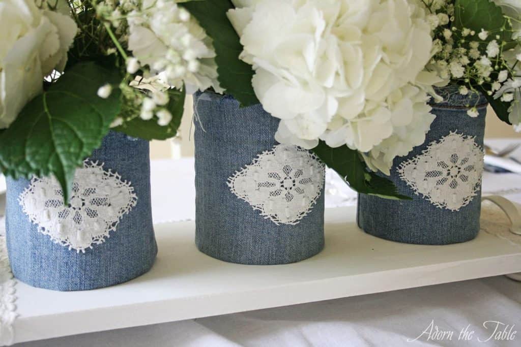 Close up of denim and white lace vases.