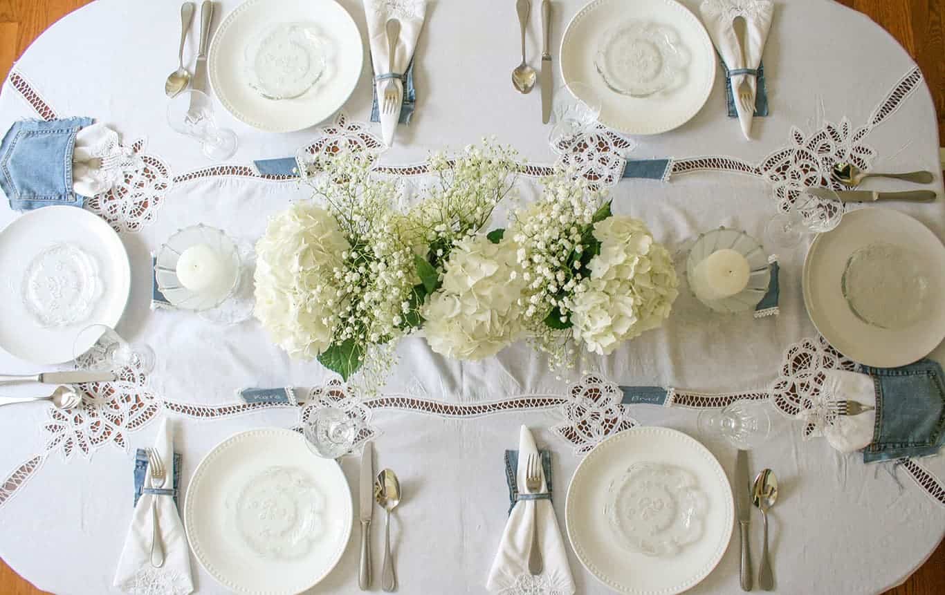 Denim and white lace tablescape. View from above, looking down.