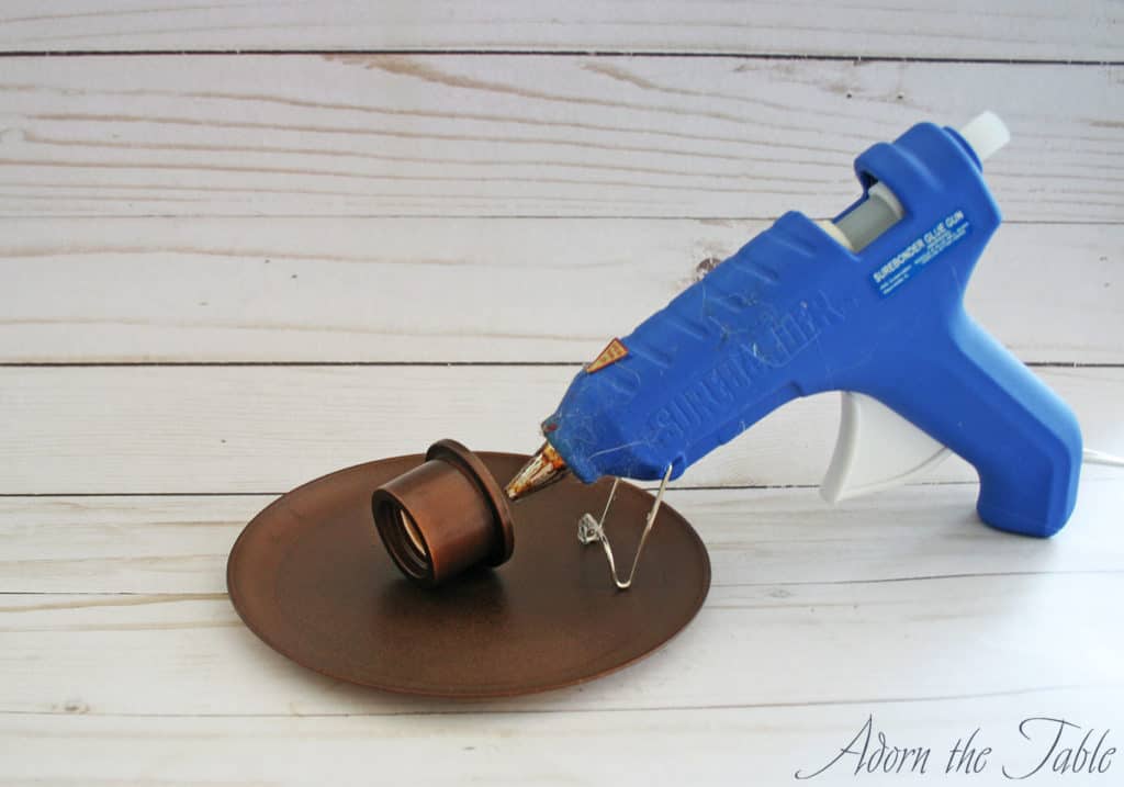 Hot glue gun with painted plate and pvc bushing.