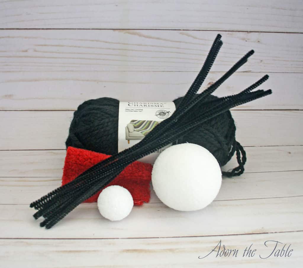 Large DIY Fake Spider supplies. Black yarn, foam ball and pipe cleaners.