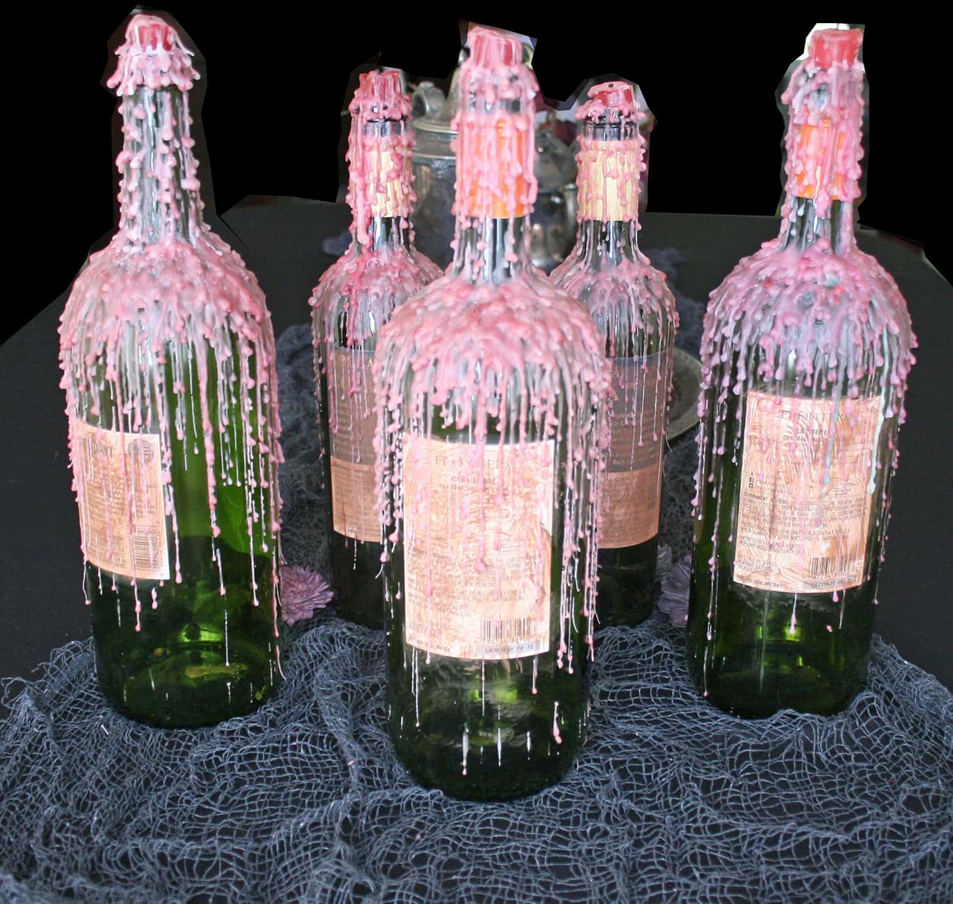 Candle wax dripped wine bottles for Halloween