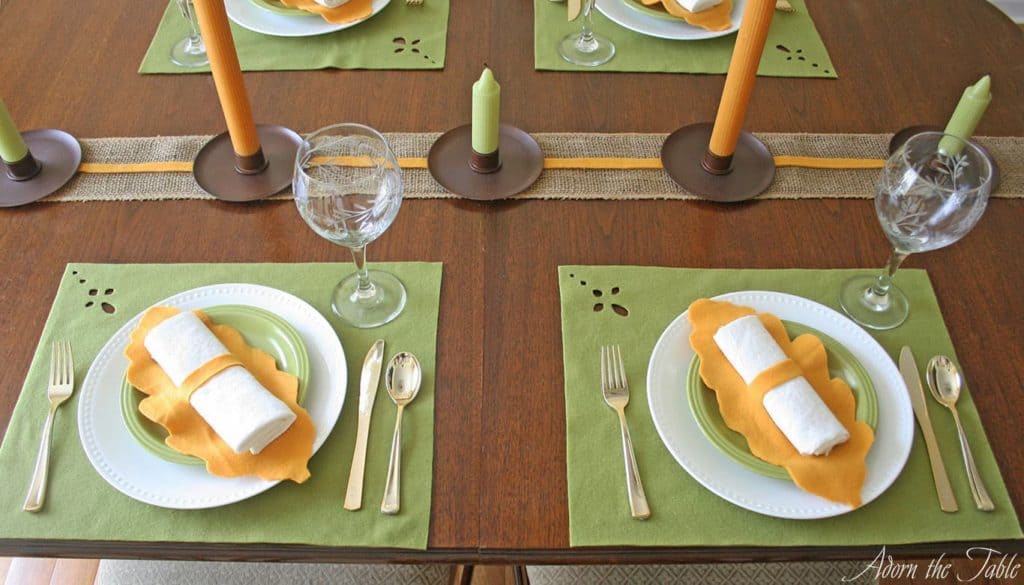 Two fall-inspired place settings using green and orange.