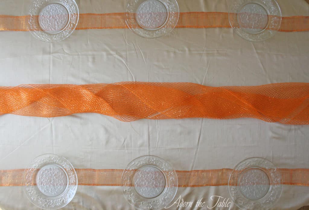 Orange mesh laid over tablecloth 