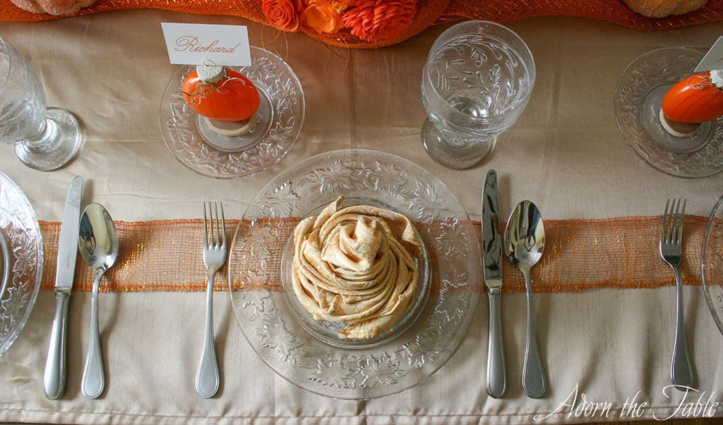 Overhead view of pumpkin and place setting on autumn tablescape