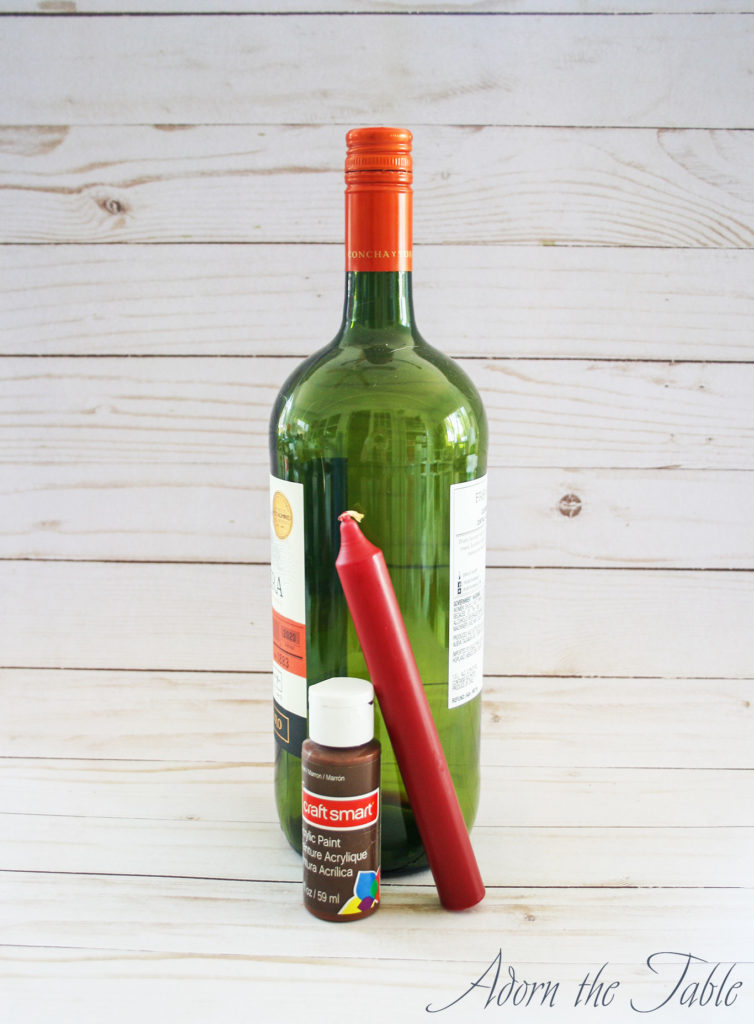 Supplies to create wax dripped wine bottle