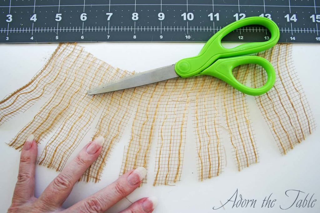 Jute mesh with scissors and ruler, cut at intervals