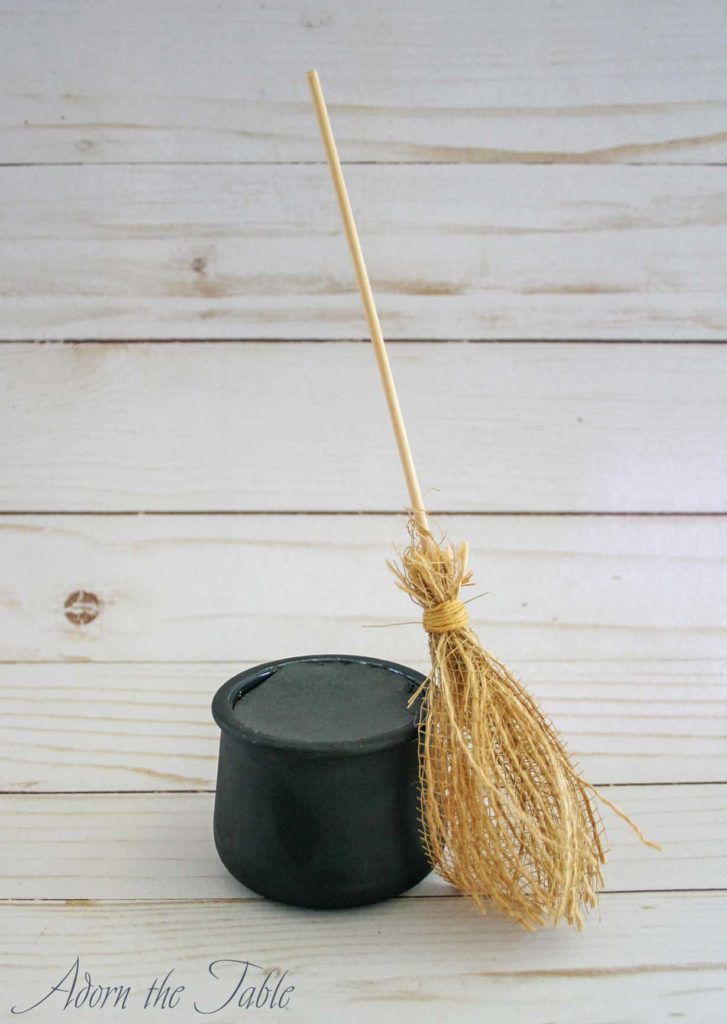 DIY witch's broomstick with small black cauldron