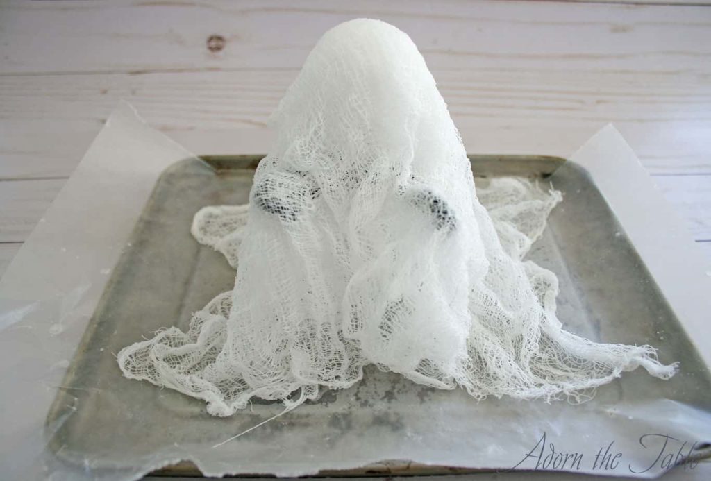 3 layers of cheesecloth draped over diy ghost form