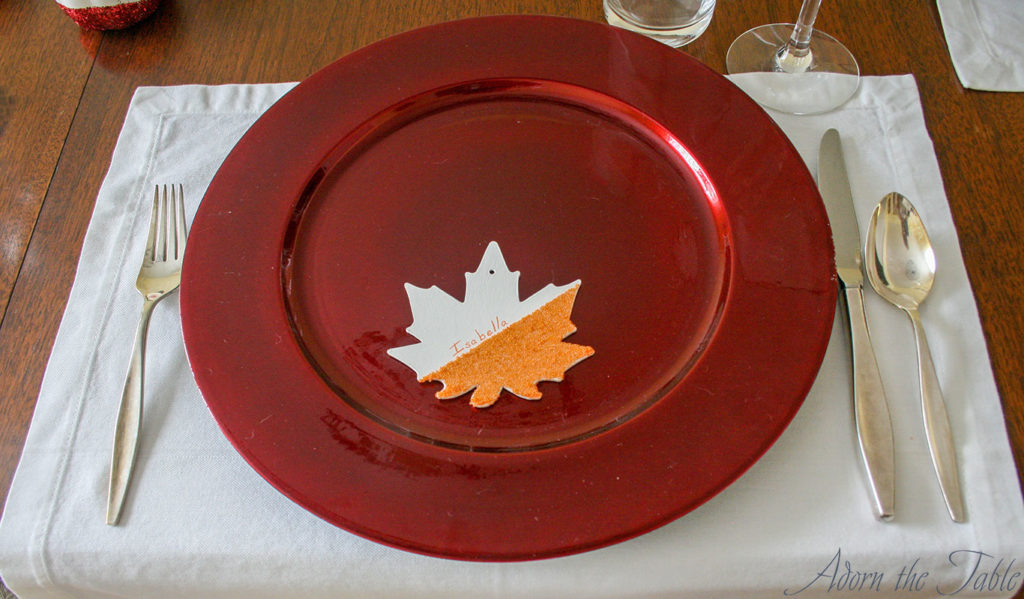 Leaf place card on red charger