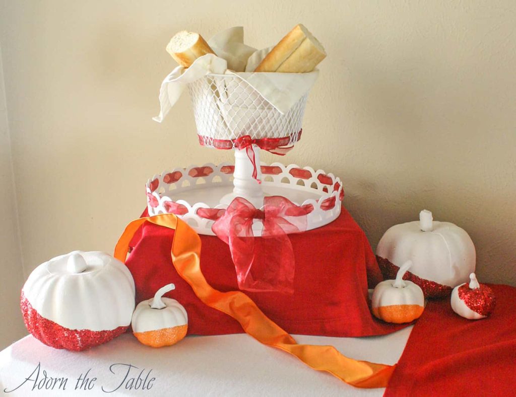 Chic minimalist Thanksgiving day buffet two-tiered serving tray with red ribbon.