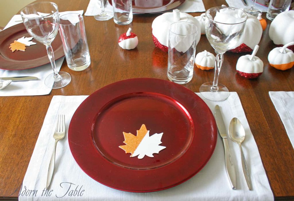 Simple modern Thanksgiving day place setting with white napkin as a placemat and silver flatware.