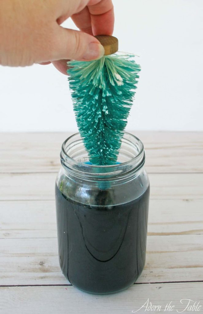Almost removed bottle brush tree from jar filled with teal RIT dye
