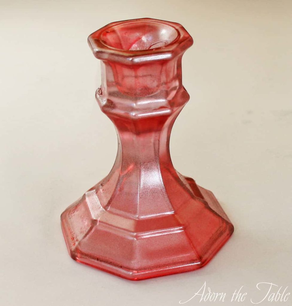 Red candle holder sprayed with mirror paint after vinegar solution