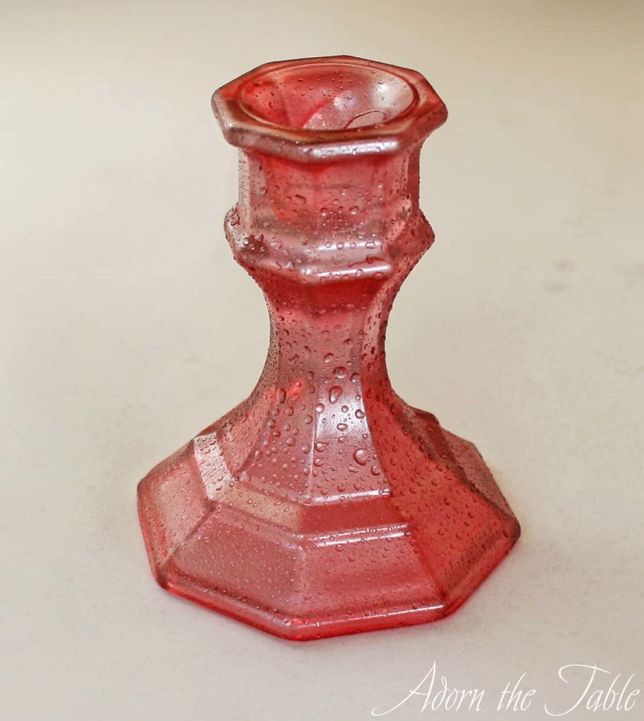 Red candle holder sprayed with vinegar mixture