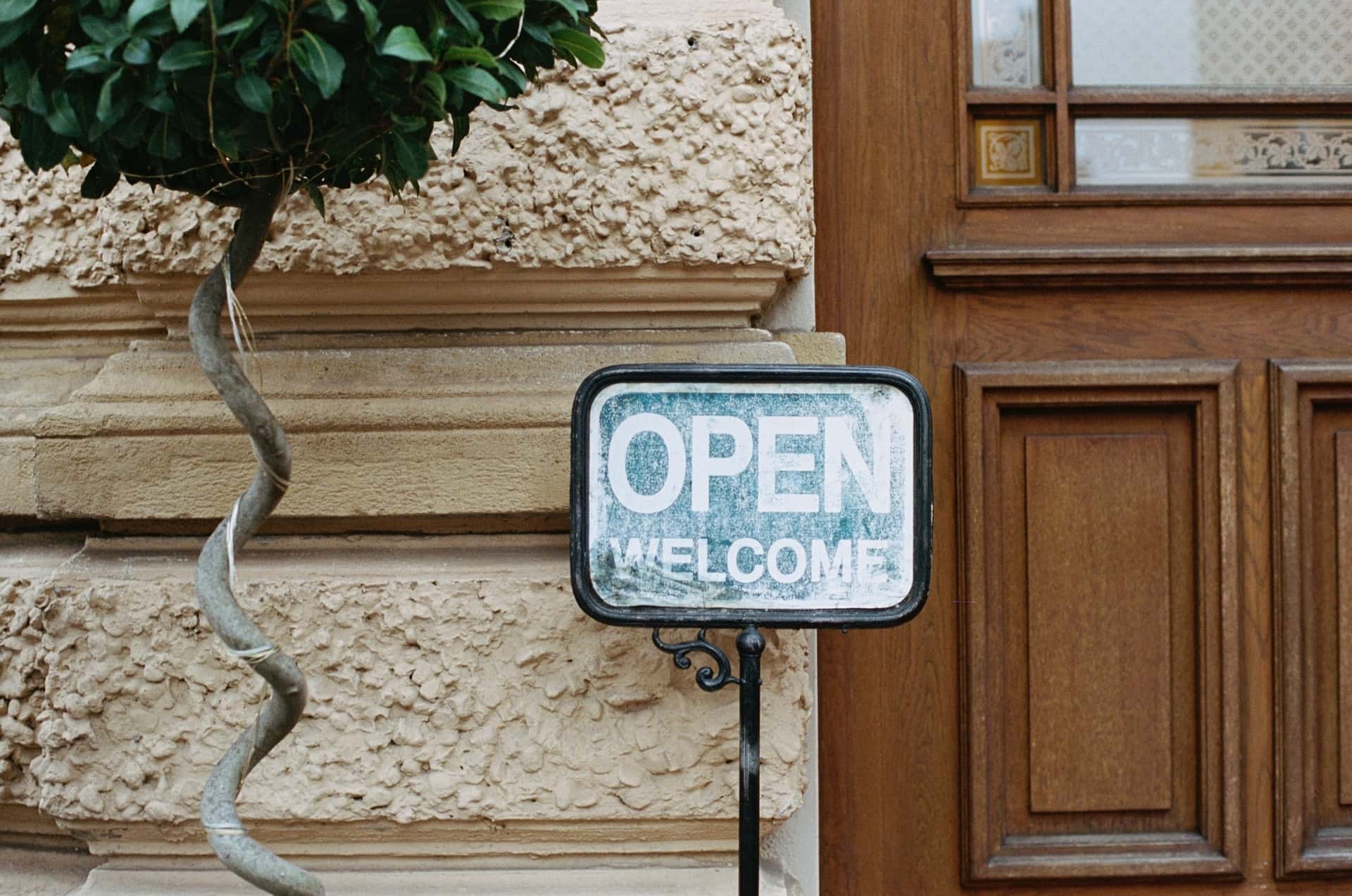 Image of Open Welcome sign outside building