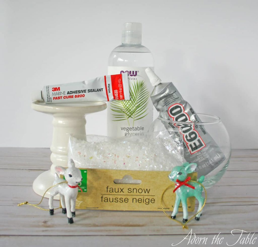 Supplies to diy a holiday snow globe with small reindeer ornaments