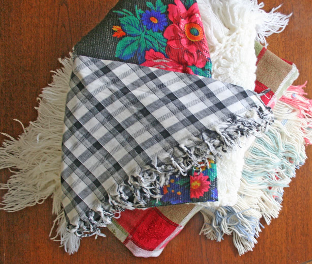 Stack of table throws and table scarves.