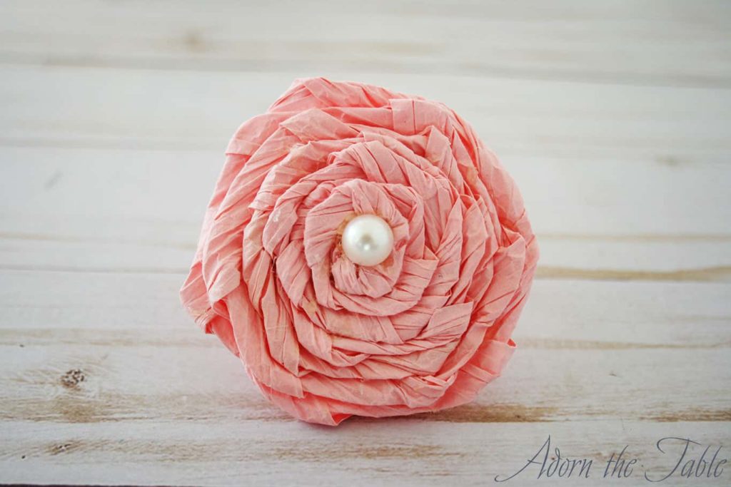 Completed pink twisted paper flower napkin ring