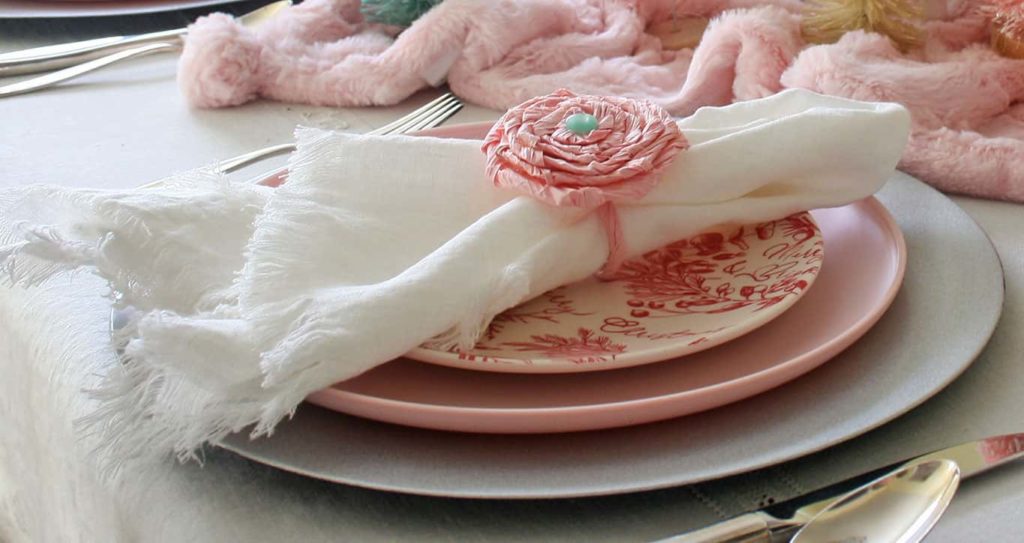 Twisted paper flower napkin ring with white napkin