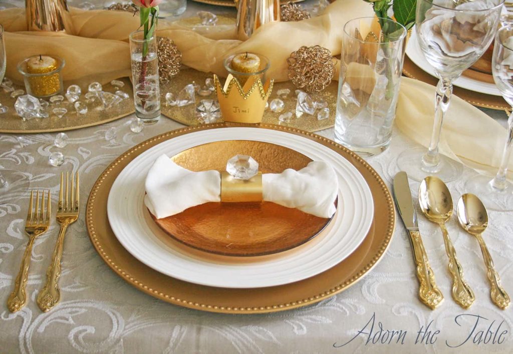 Close up view of gold and white place setting