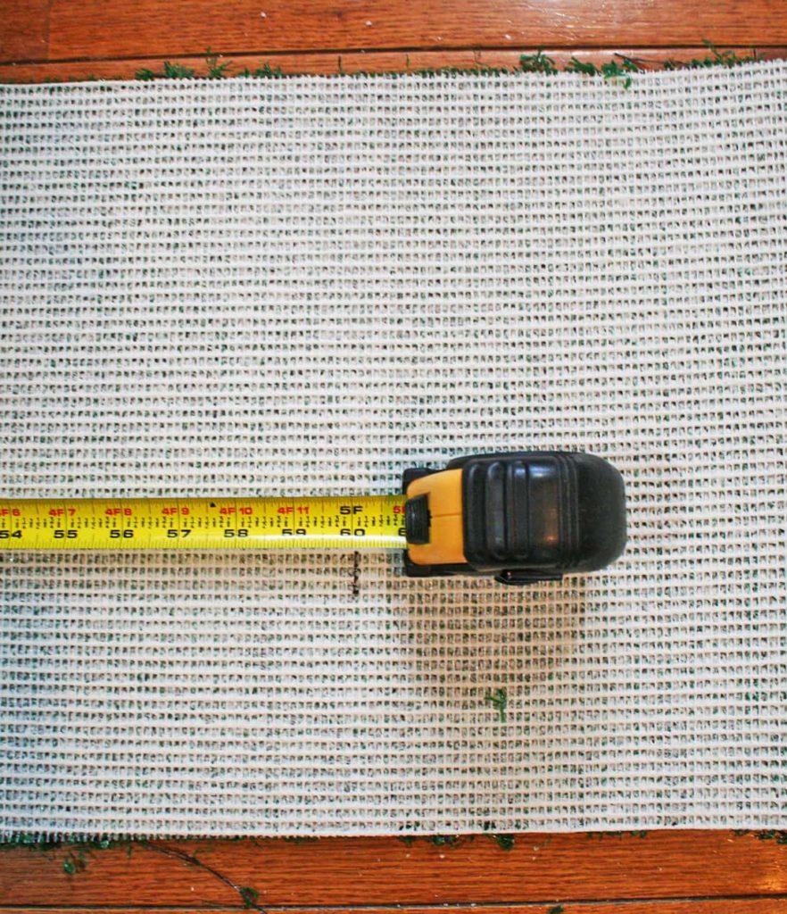 Tape measure on back of fake turf