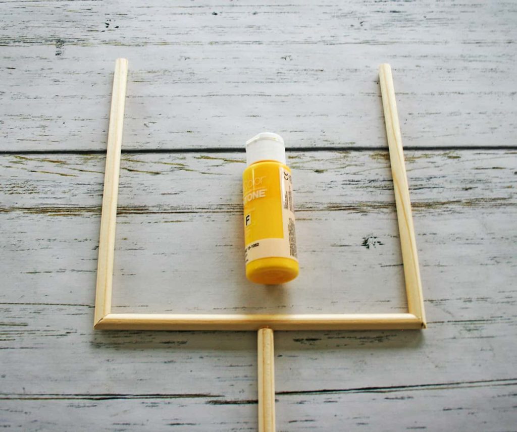 Yellow paint and wooden dowel football goalpost